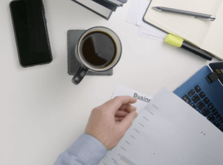 coffee, phone, documents on desk